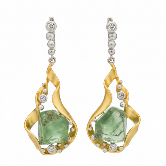 Gold earrings with green gemstones on a white background