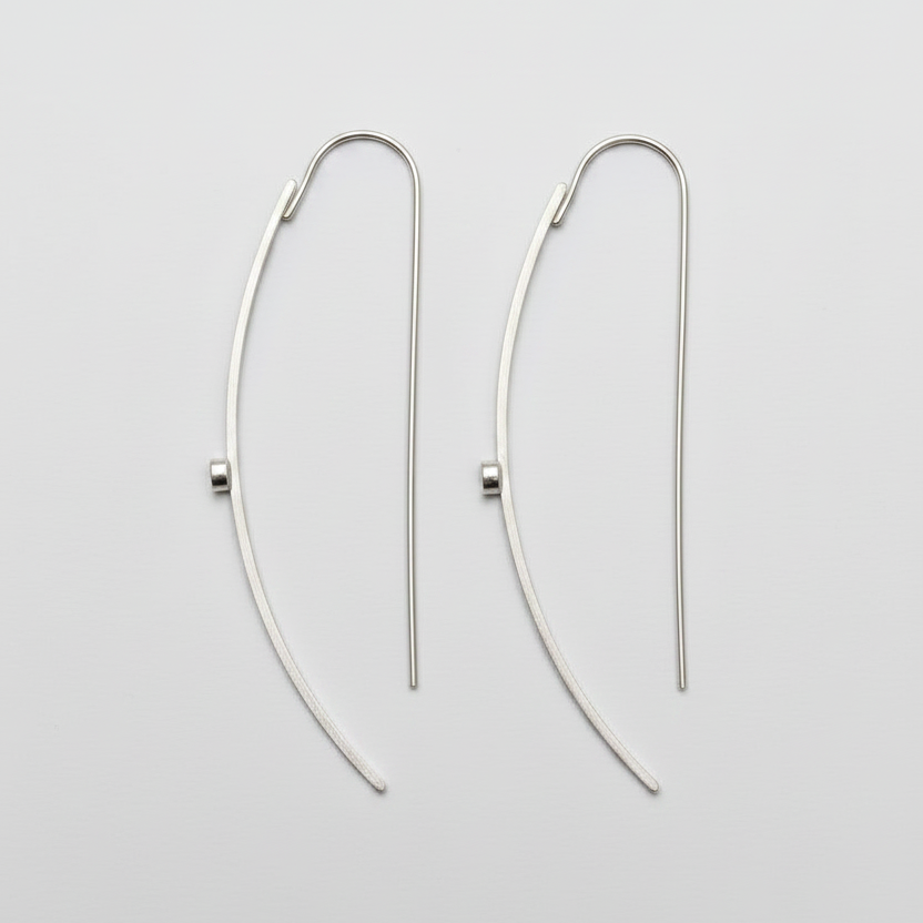 Pair of silver hoop earrings on a light gray background