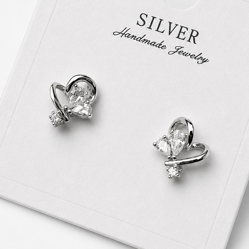 Silver butterfly-shaped earrings on a 'Silver Handmade Jewelry' card.