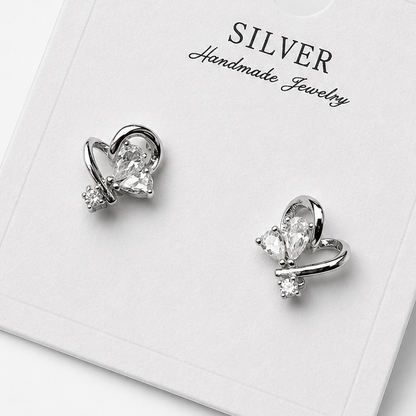 Silver butterfly-shaped earrings on a 'Silver Handmade Jewelry' card.