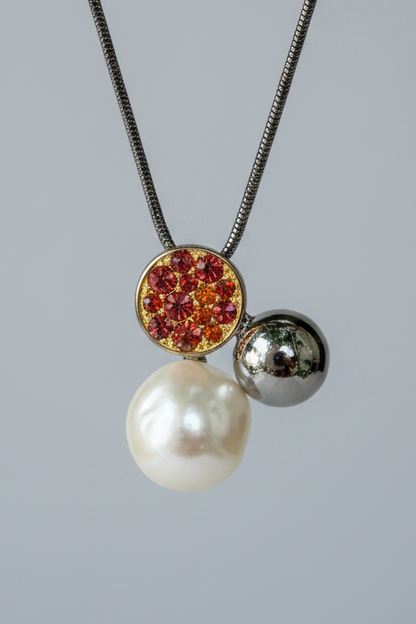 Necklace with three pendants on a gray background