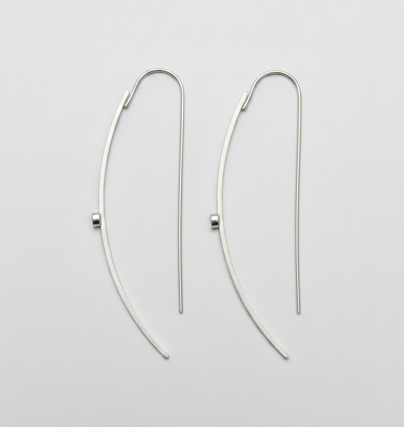 Pair of silver hoop earrings on a light gray background