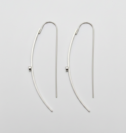 Pair of silver hoop earrings on a light gray background