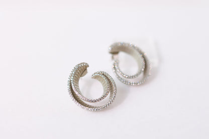 Pair of silver hoop earrings on a white background