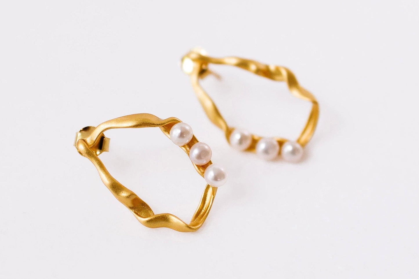 Gold hoop earrings on a white background
